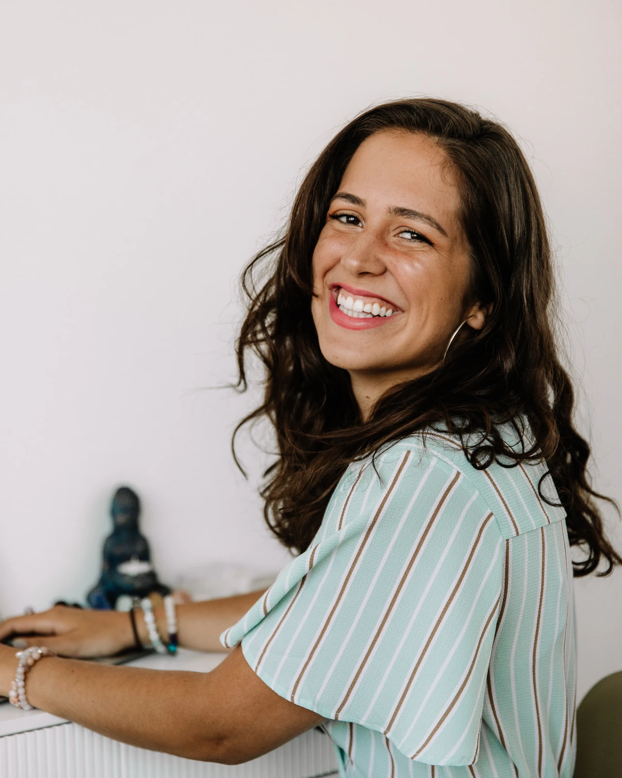 Emily Parolin, smiling, at her workspace